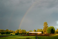 the stables at rock springs guest ranch and a rainbow